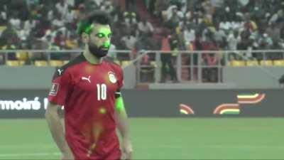 Mo Salah taking a penalty for Egypt with laser pointers in his eyes earlier today
