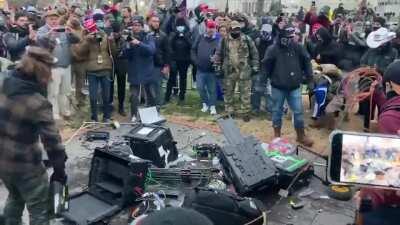 Trump supporters destroying media tech equipments outside the Capitol building