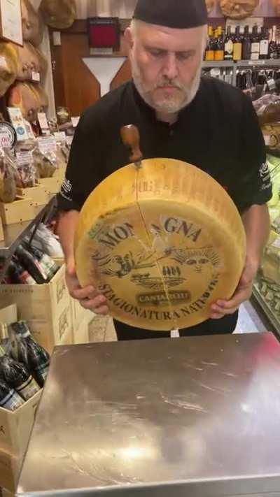 Cracking open a wheel of Parmigiano Reggiano cheese
