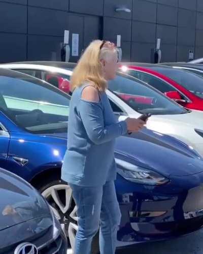 Karen throws a fit because she was told she can't park in a reserved spot at a Tesla dealer