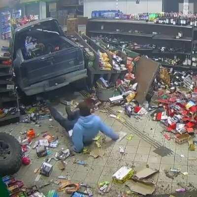 Guy crashes car into Michigan gas station, and then attempts to remove the license plate before fleeing