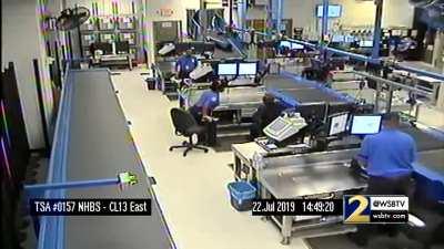 Kid goes for a conveyor belt ride through the baggage-handling area