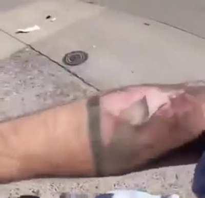 Biker safely slides under truck to avoid collision