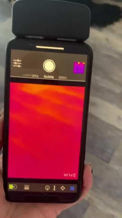 Thermal imaging phone attachment showing radiant heat