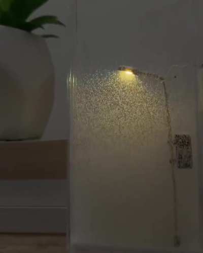 Snowfall by street lamp, night light