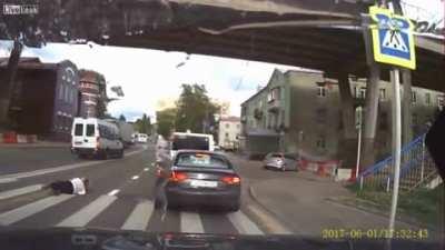 Woman talks on the phone while crossing, gets hit by van.