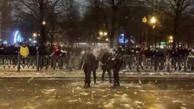 Navalny protesters pelting police with snowballs in Moscow.