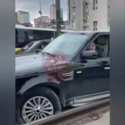 SUV driver mounts the rails to evade traffic