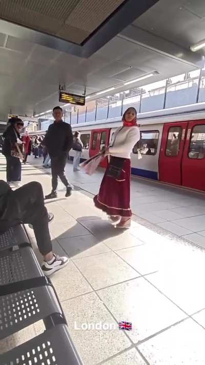Gypsy woman spits on man after he refuses to accept a rose in London.