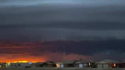 Shelf cloud with a sunset in the background