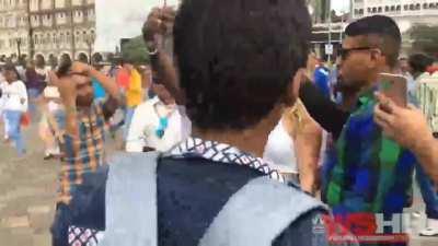 Dozens of men harass a white tourist in mumbai, INDlA