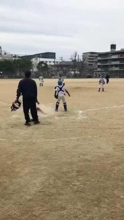 Japanese kid manages to make contact on a very high pitch for an RBI sac bunt.