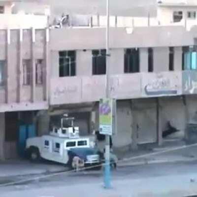 Someone throwing explosives at a Hummer from a roof top. Iraq. Undated video.