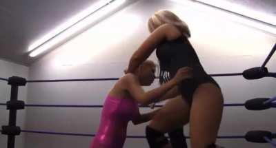 The younger pretty in pink girl gets bullied, choked and even put in a camel clutch by the older more experienced wrestler