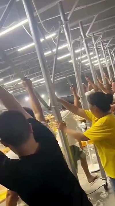 Several people sent flying by powerful winds when they tried to hold onto the canopy at a restaurant in China