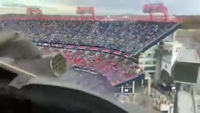 In-cockpit view of Low level overflight over an NFL game