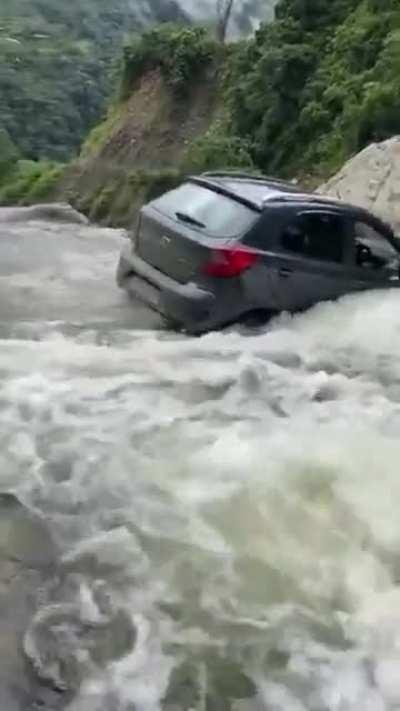 Trying to cross a waterfall with a 95 hp , front wheel drive hatchback .