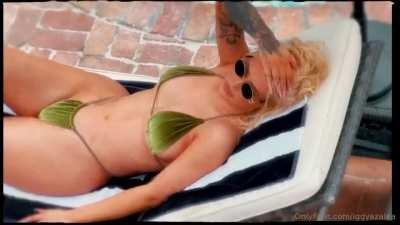 Iggy Azalea laying poolside in thong