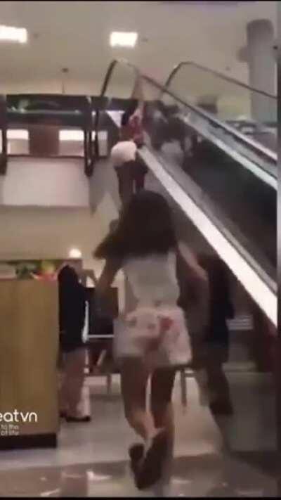 Holding on to the side of an escalator