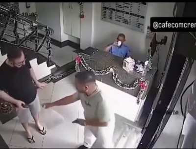 Security guard sips coffee during robbery. 
