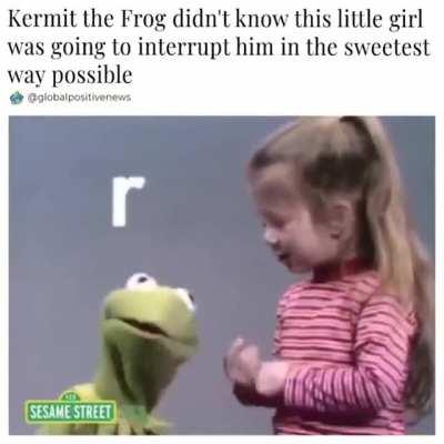 Little girl interrupting Kermit the Frog