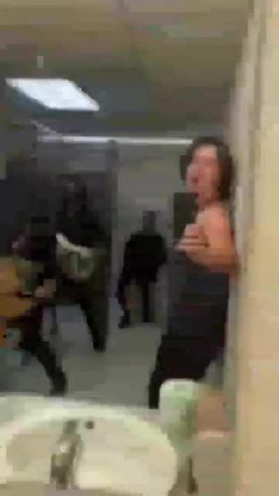 Just some guys being dudes in the bathroom.