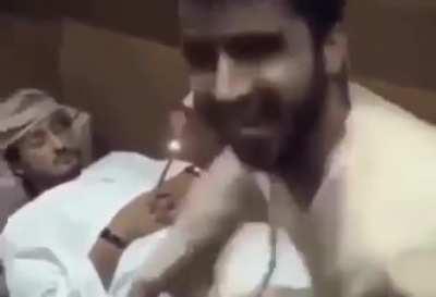 man put a rocket between his friend's hand while he was asleep