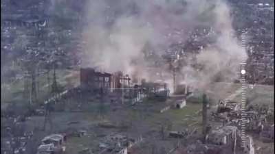 Drone footage of a Russian position in the city of Toretsk getting attacked by a Ukrainian 2S7 