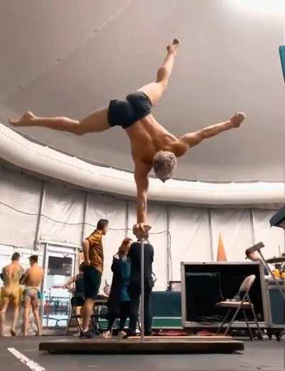 An acrobat hand balancing