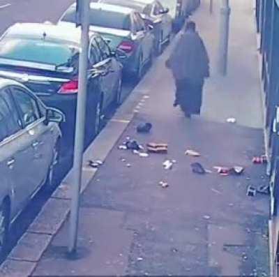 Woman cleans sidewalk
