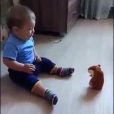 Baby scared of talking hamster toy