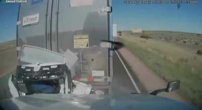 Car gets compressed between two trucks