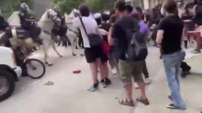 Cop on horse turning peaceful protest violent