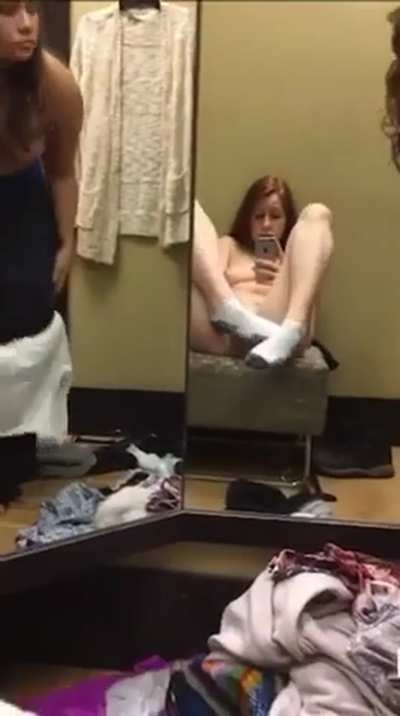 Jilling while her friend tries on new clothes