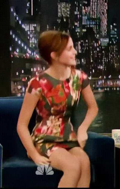 Emma Watson adjusting her dress 