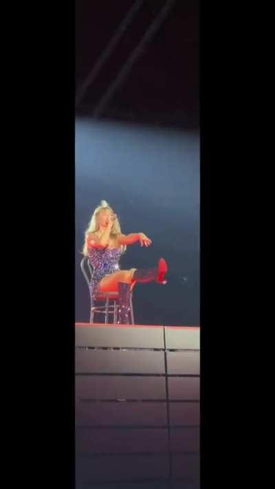 Sitting on a chair, spreading her legs