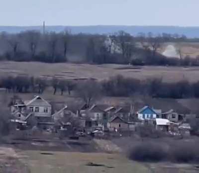 Ukrainian forces work on a Russian position in the treeline, Donetsk province