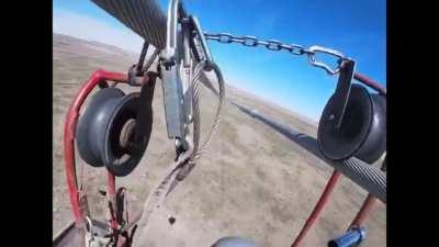 Lineman&rsquo;s cart slips off the wires. He has to fix it so he get get off the lines.