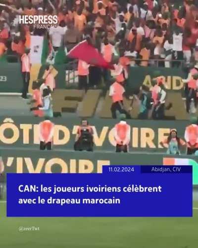 Ivorian players celebrate with a Moroccan flag following their CAF victory