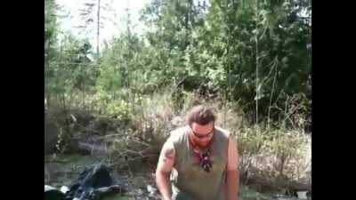 WCGW throwing a piece of flaming cardboard onto a bonfire with 5 gallons of gas on it