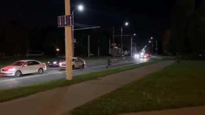 Man in Belarus escapes riot police by jumping into a taxi car which drives away instantly