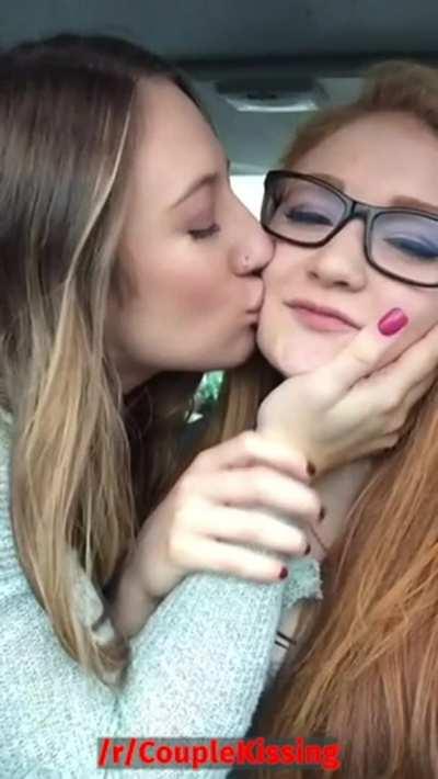 Two cute lesbians kissing passionately in the car