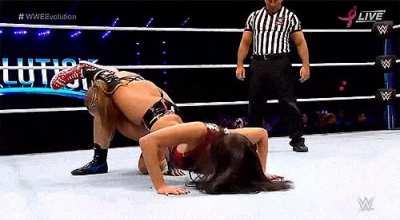 Nikki Bella Embarrassing Ronda with a Headscissors-Pushup combo.