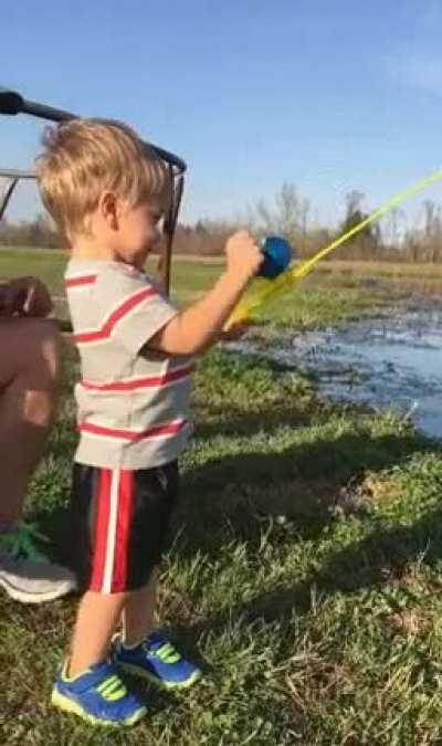 Kid catches fish with toy fishing rod