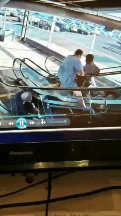 Old couple struggle with escalator