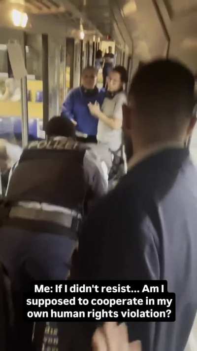 German police beating wheelchair user for sitting on a non wheelchair seat.