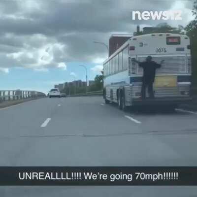 MAN CLINGS TO NYC BUS: Man seen hanging on to the back of an MTA bus yesterday on the Harlem River Drive. (Courtesy: Jordan Caruso)