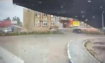 Wind blows the roof off the shopping center of a small village damaging a single car.