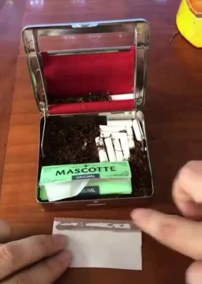 A cigarette rolling case.