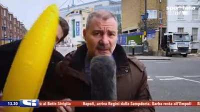 Disturbing a reporter with a giant banana.